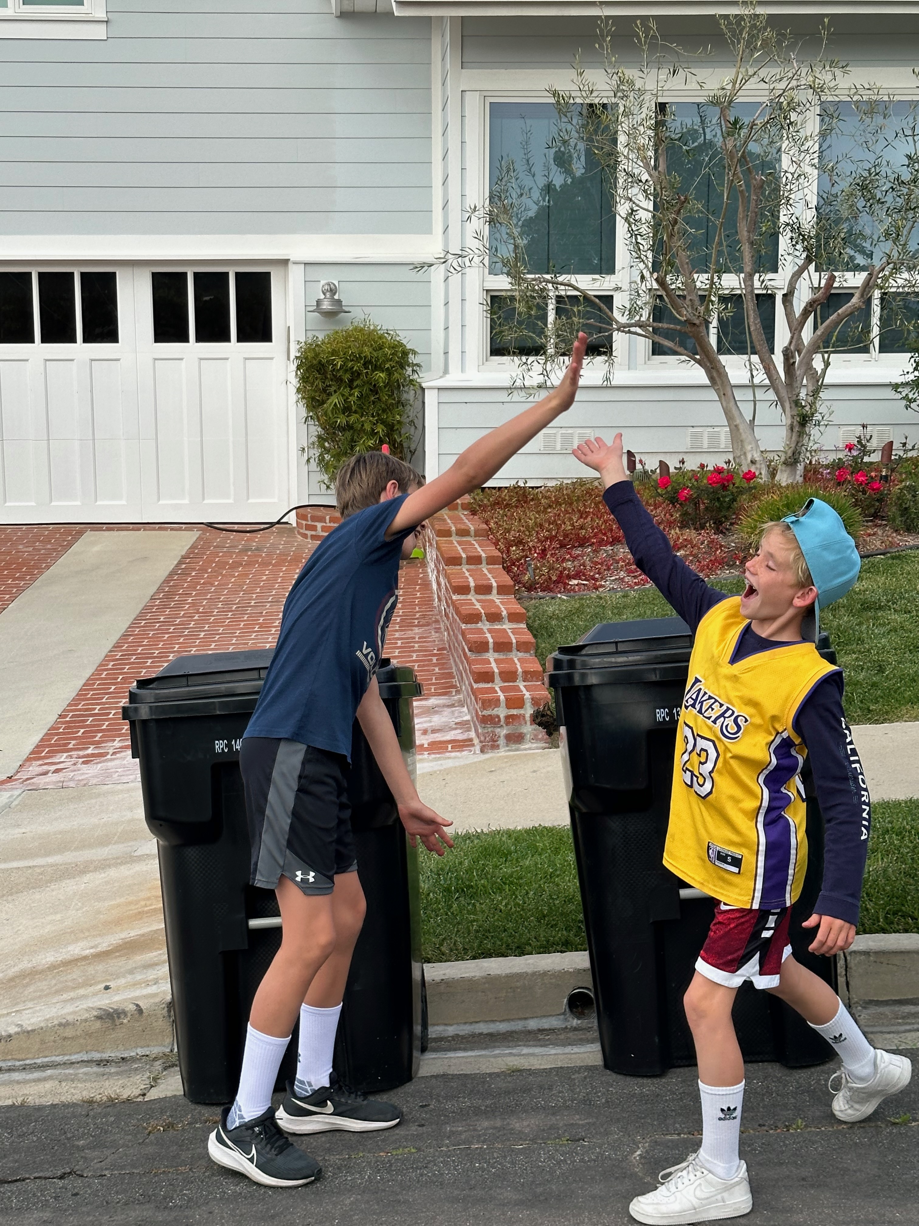 Mark and Matt celebrating after completing their trash can service route